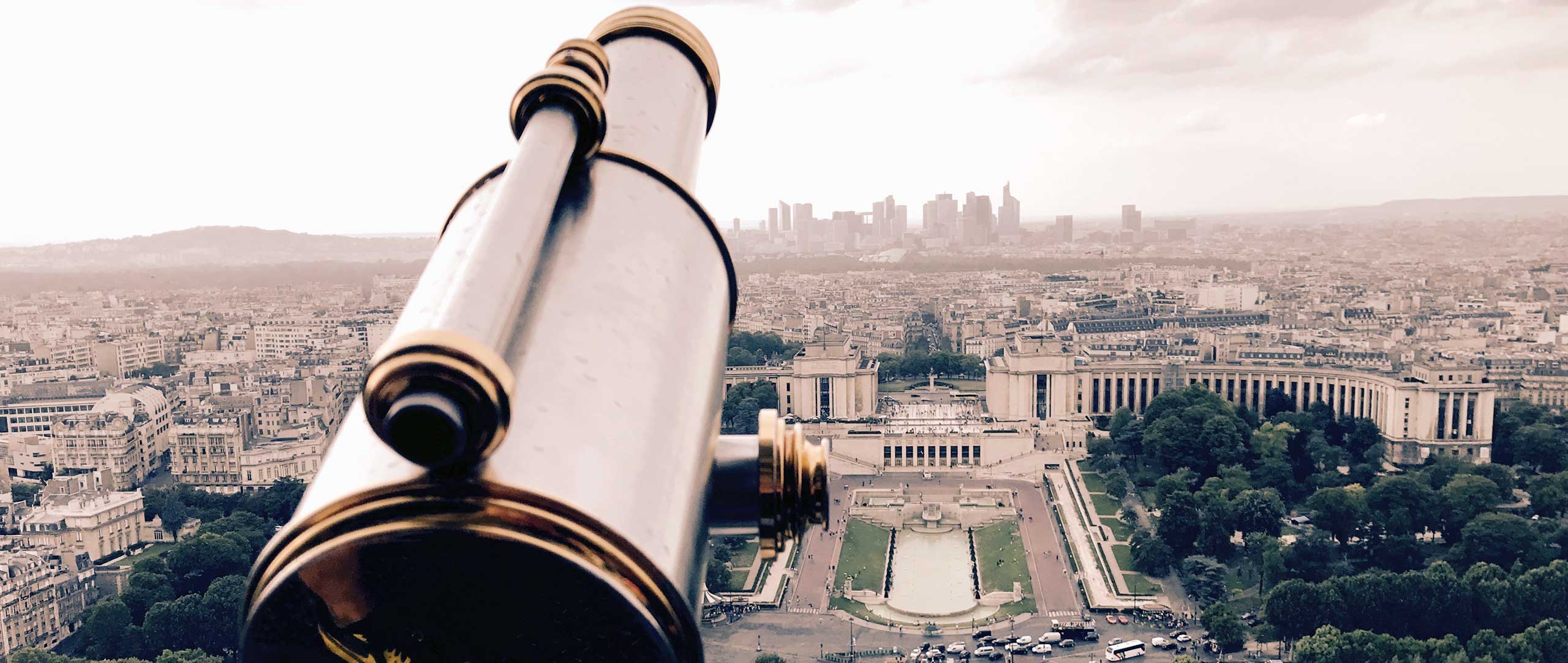 On top of Eiffel Tower next to some binoculars.